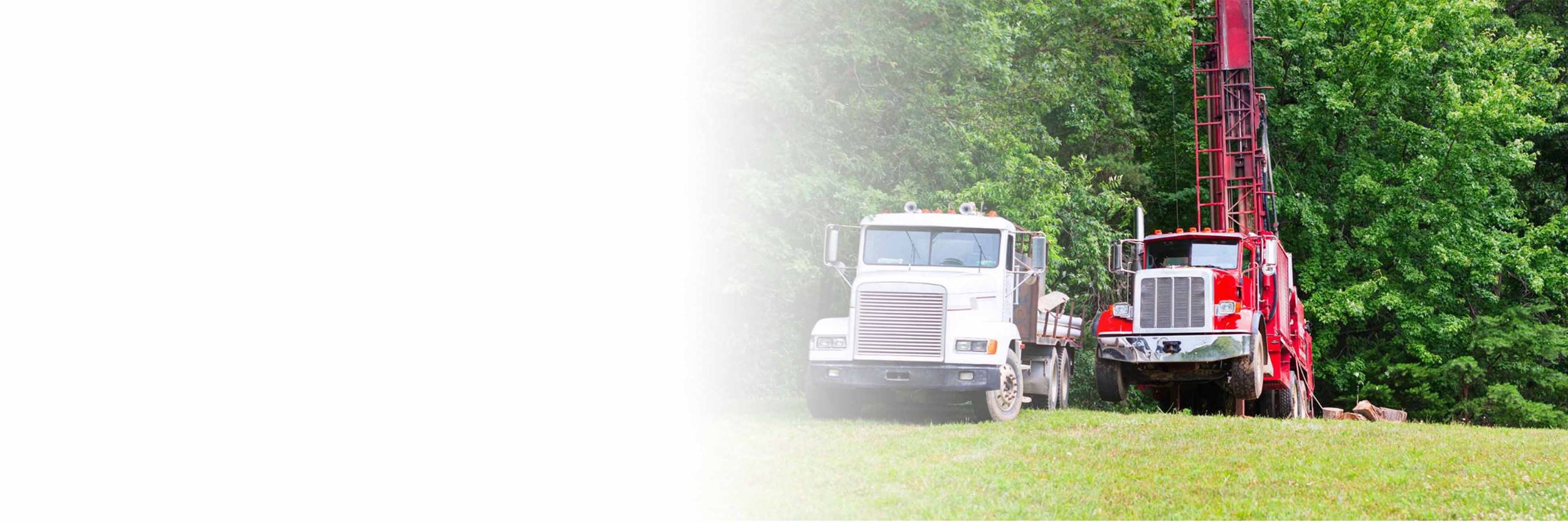 Two water trucks in field